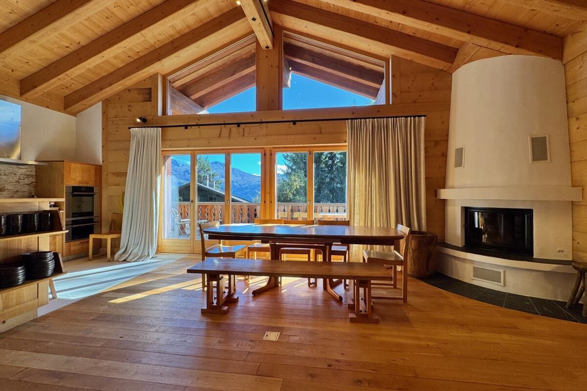 A dining room with a table and chairs and a fireplace