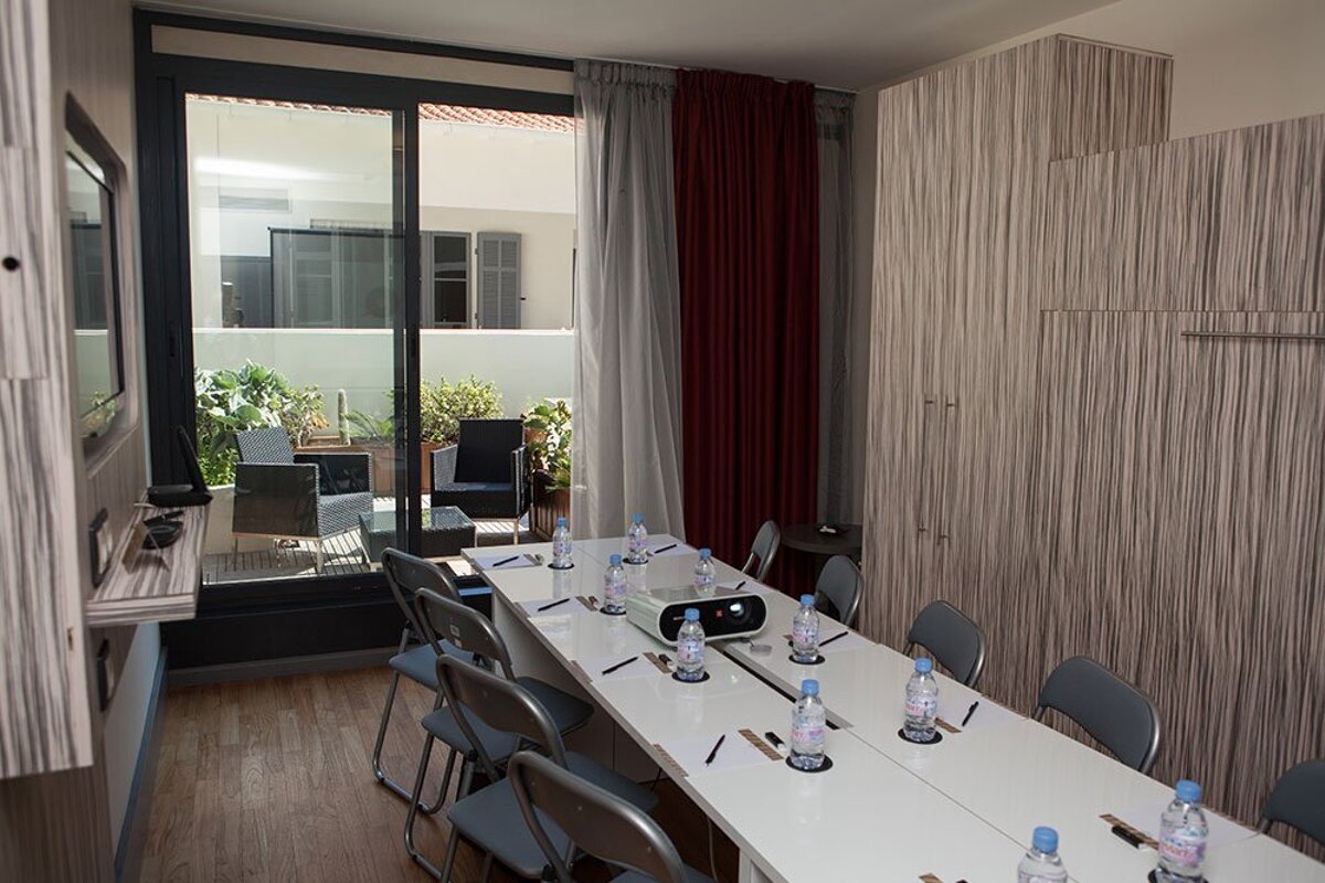 A conference room with a long table and chairs