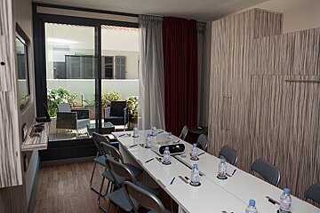 A conference room with a long table and chairs