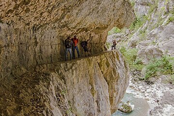A group of people standing on the side of a cliff