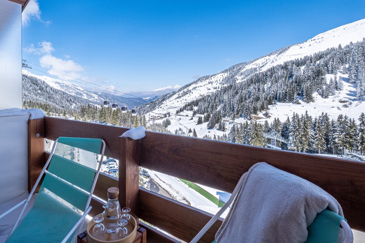 A balcony with a view of a snowy mountain range