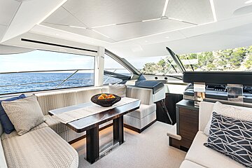 A boat has a table with a bowl of fruit on it