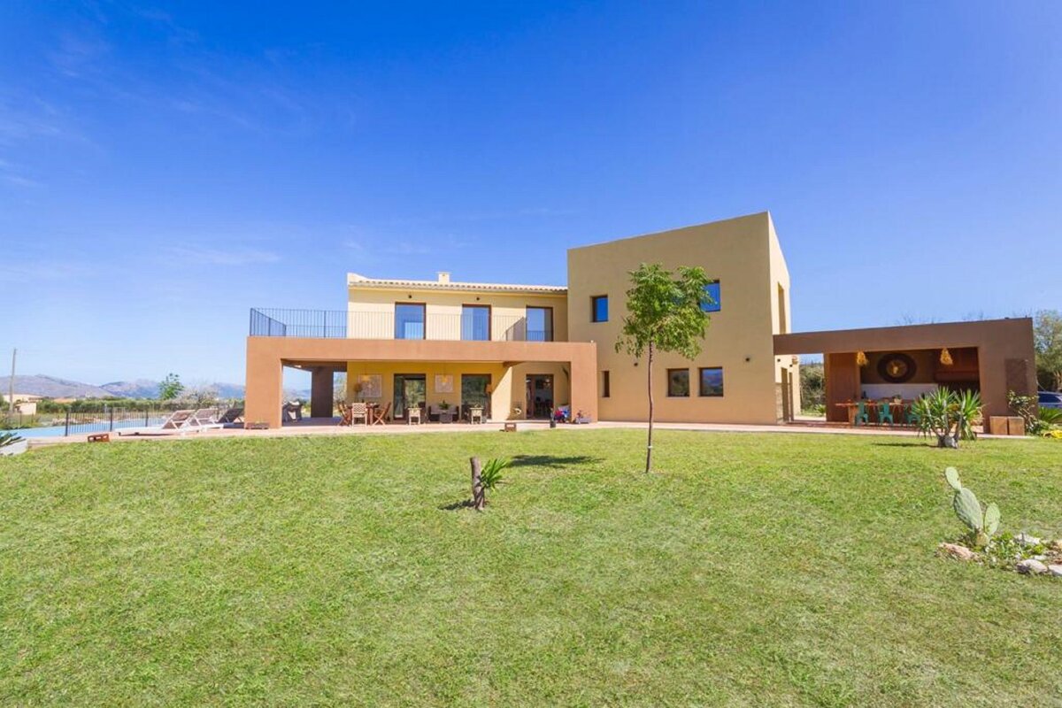 A large house with a large lawn in front of it