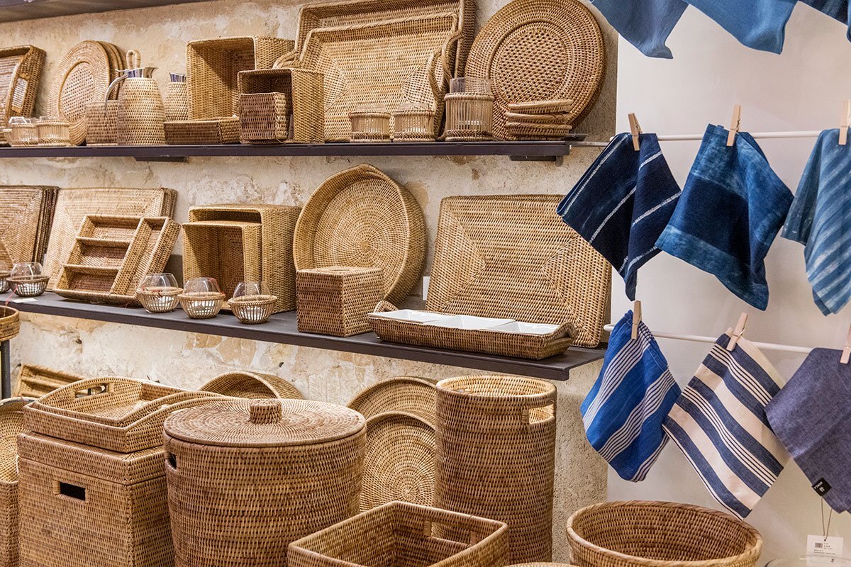 A shelf full of wicker baskets and plates