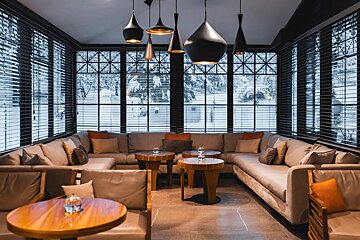 A living room with a lot of furniture and tables