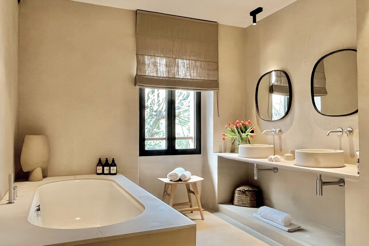 A bathroom with two sinks and a window