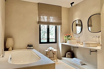 A bathroom with two sinks and a window