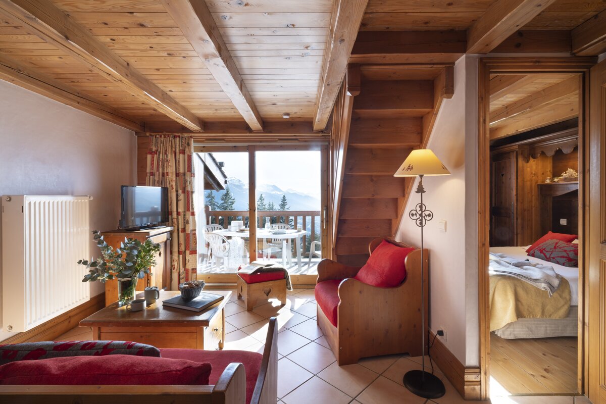 A living room with a staircase leading up to the second floor