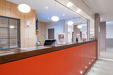 A red counter with a sign that says ' boutique ' on it