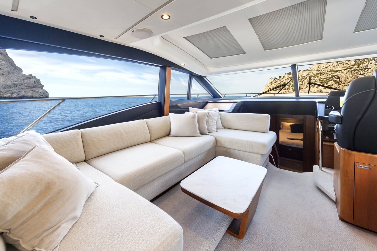 The inside of a boat with a couch and a table