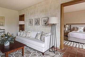 A living room with a white couch and lamps