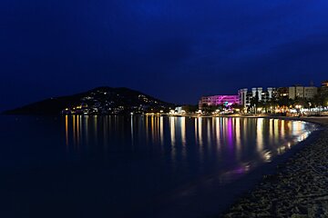 A beach at night with a lot of lights on