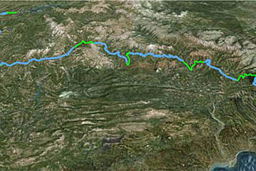 An aerial view of a river running through a mountainous area