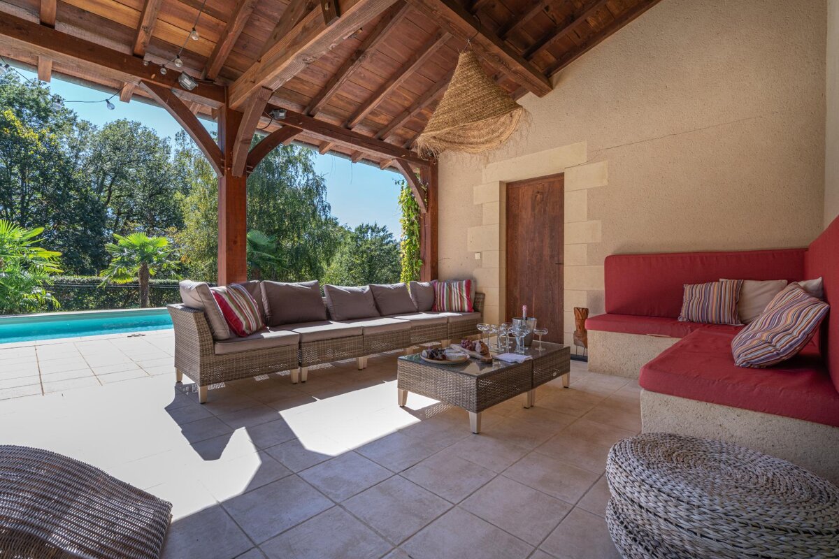 A patio area with a couch and a coffee table