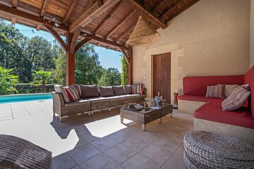 A patio area with a couch and a coffee table