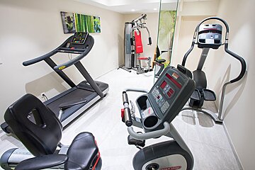 A gym with treadmills and a star trac exercise bike