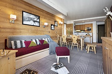 A living room with a couch a table and chairs