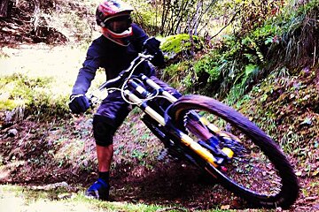 a mountain biker skidding round a corner