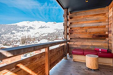 A balcony with a view of a snowy mountain range