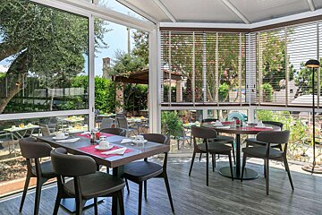 A restaurant with tables and chairs and a large window