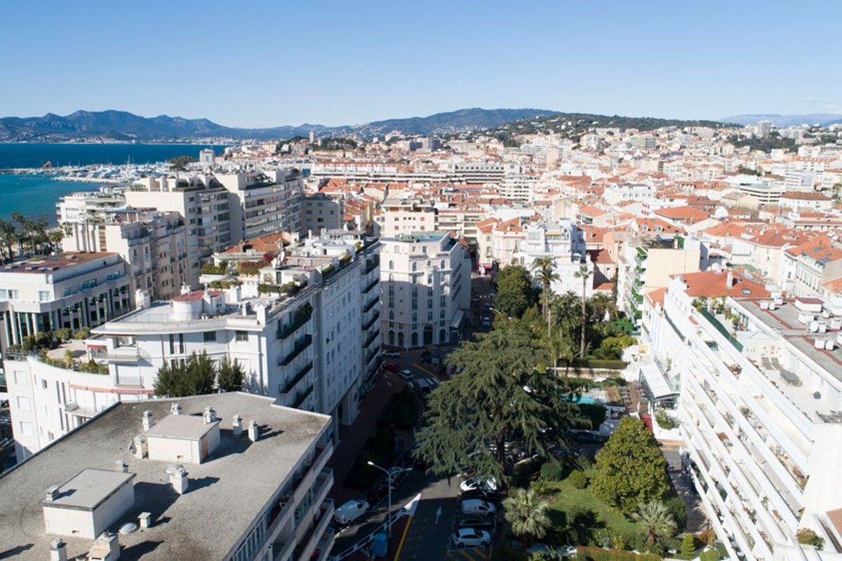 An aerial view of a city with mountains in the background
