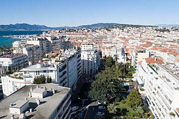 An aerial view of a city with mountains in the background