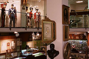 A museum with a display of military uniforms and memorabilia