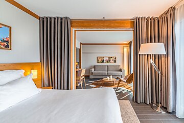 A hotel room with a bed and a couch