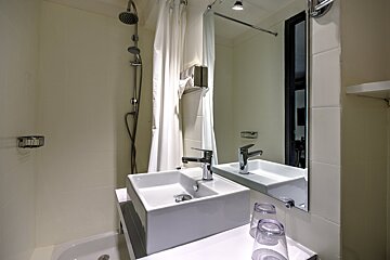 A bathroom with two sinks and a mirror