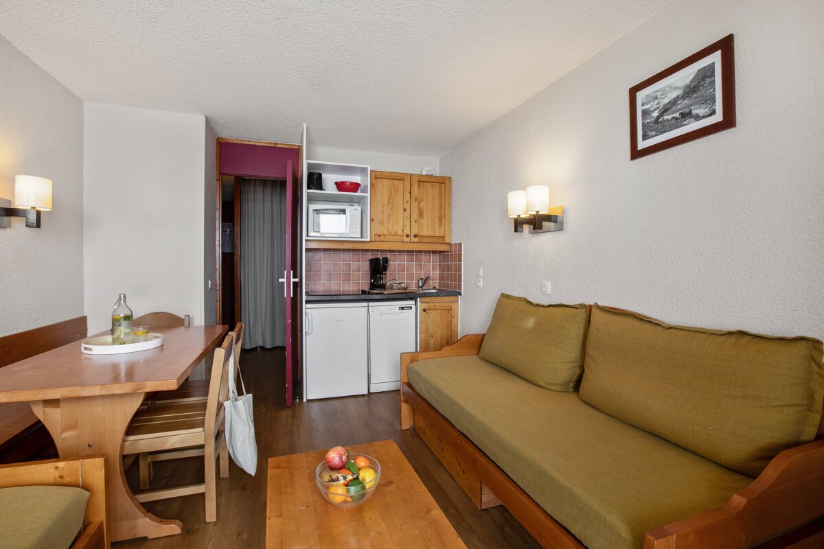 A living room with a couch a table and a picture on the wall