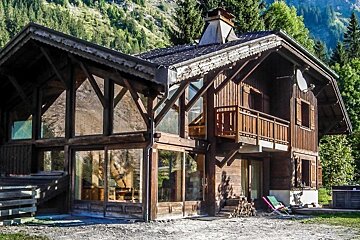 a chalet with large glass windows