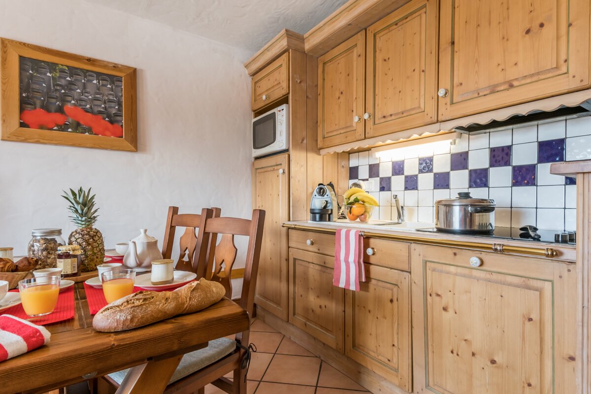 A kitchen with wooden cabinets and a stove top oven
