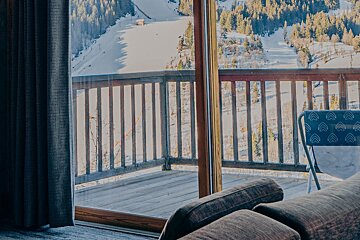 A balcony with a view of a snowy mountain