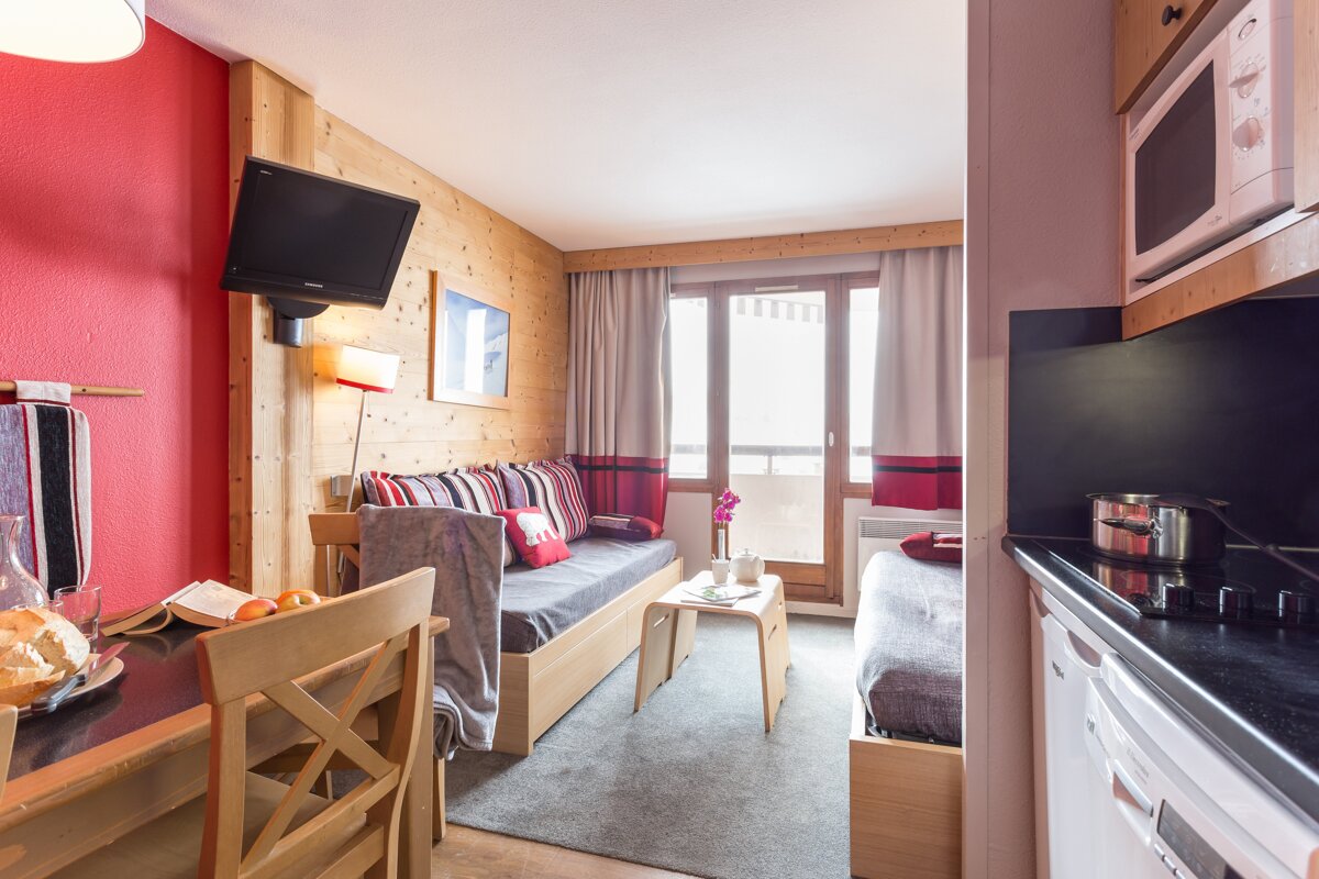 A small living room with a couch and a microwave