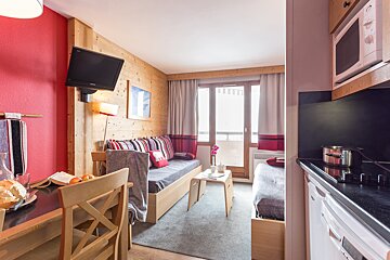 A small living room with a couch and a microwave