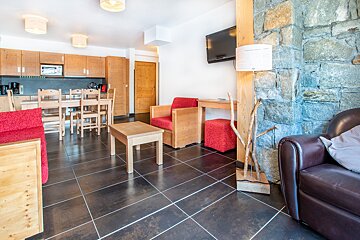 A living room with a couch a chair a table and a television