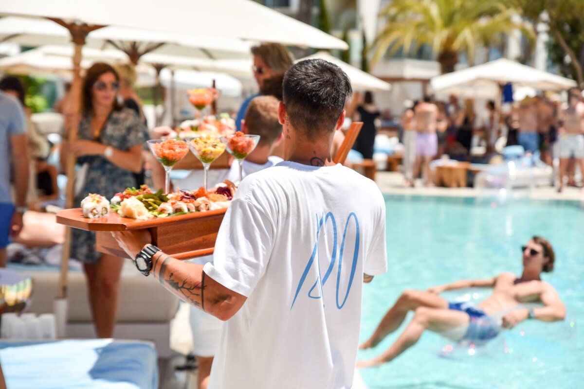 A man wearing a white shirt with the number 20 on the back