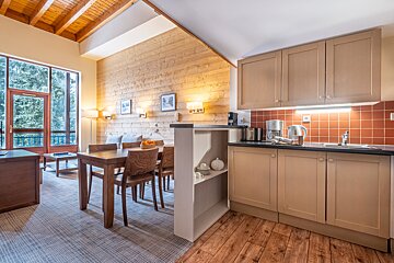 A kitchen with a table and chairs in it