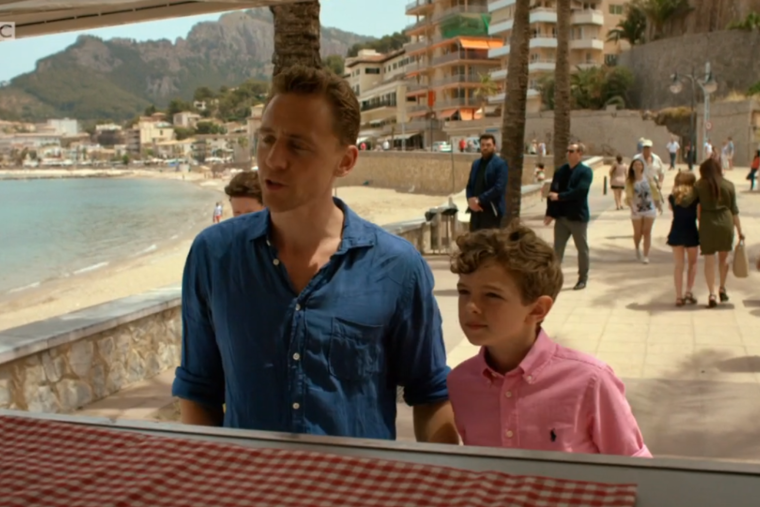 A man in a blue shirt stands next to a boy in a pink shirt with bbc written on the bottom