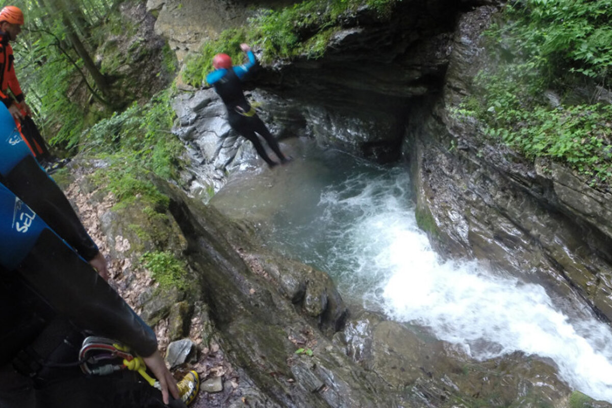 a guide with people jumping into a river