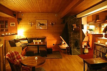 A living room with a picture of a horse on the wall