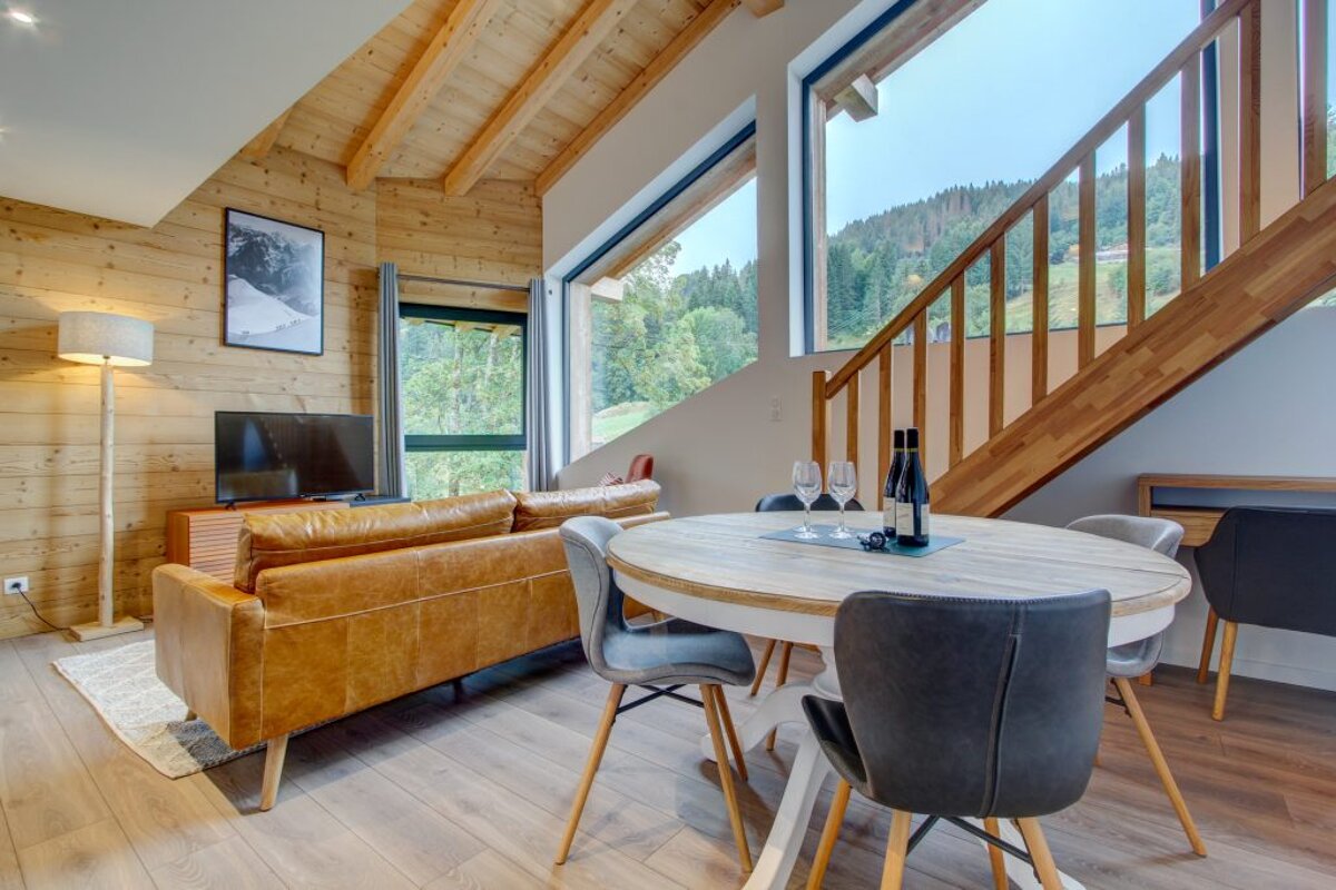 A living room with a brown couch and a white table