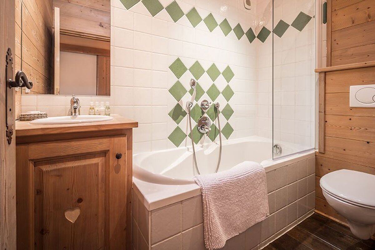 A bathroom with a bathtub a sink and a toilet