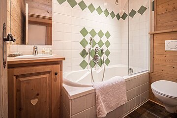 A bathroom with a bathtub a sink and a toilet