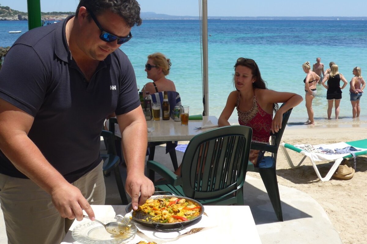 a man serving himself some paella