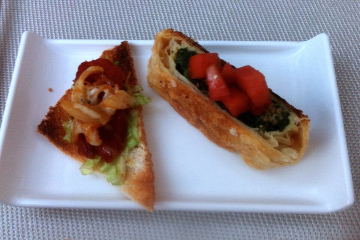 two pieces of tapas on a white plate