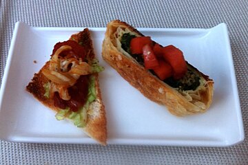 two pieces of tapas on a white plate