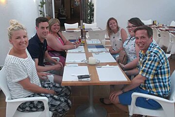 6 people at a dining table in a restaurant