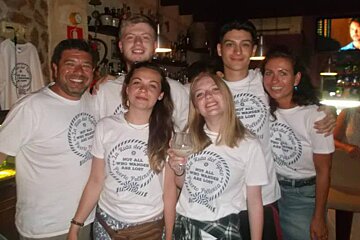 a group of people wearing a tapas tour tshirt