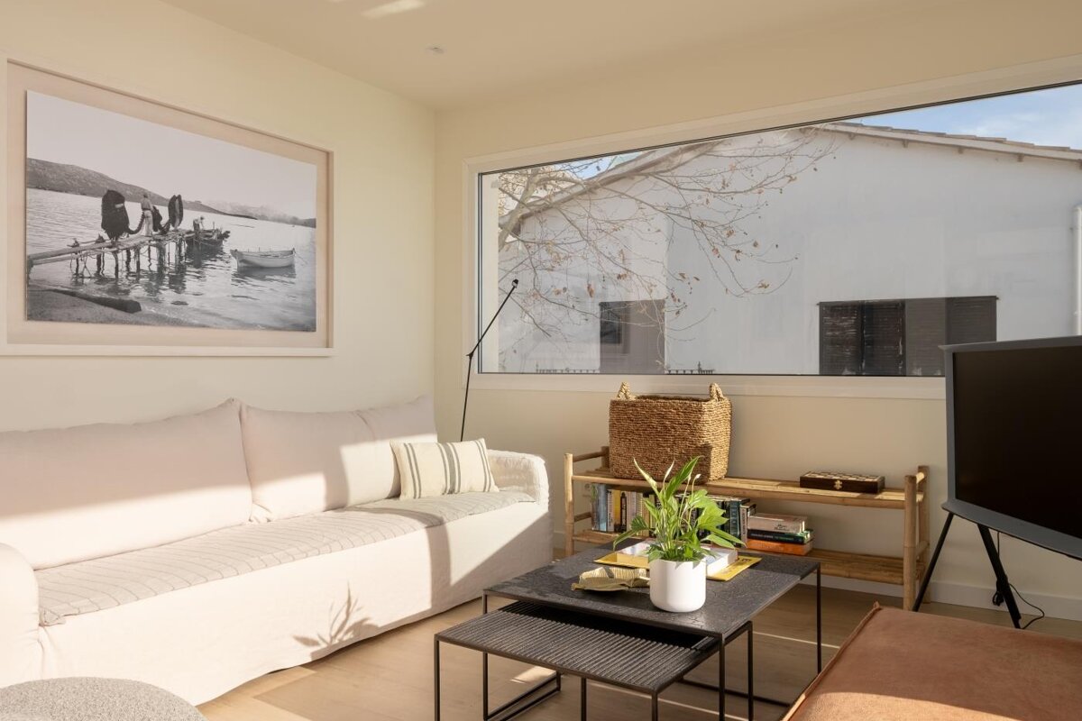 A living room with a couch and a picture on the wall